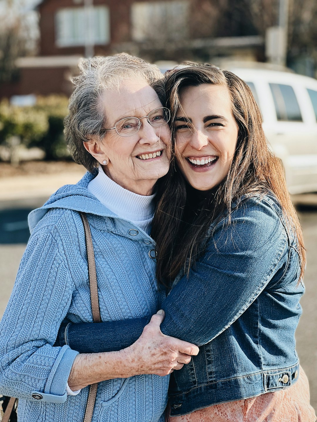two-women-hugging-each-other-in-a-parking-lot-gikzhdpjmp0